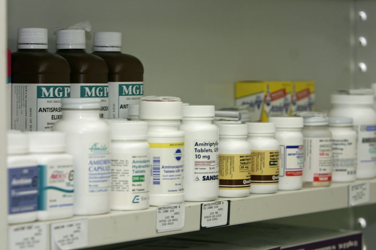 Shelves of medicine bottles in a pharmacy
