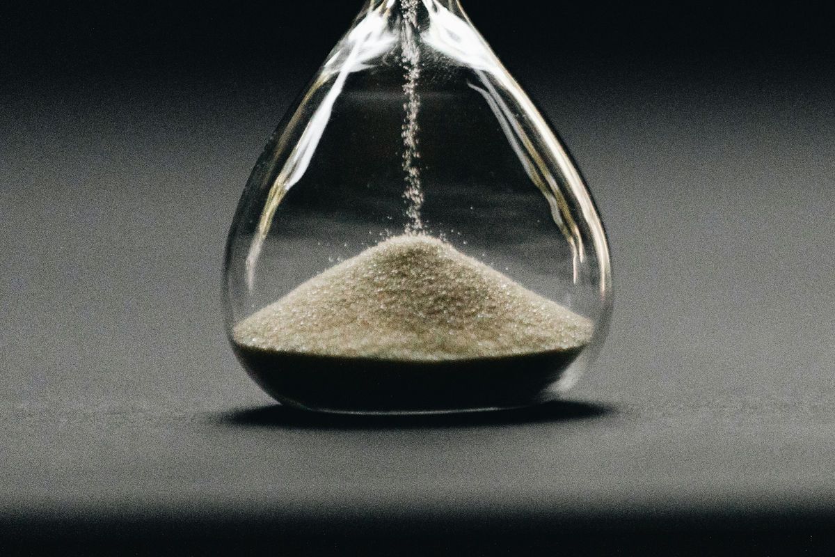 An hourglass with sand running through