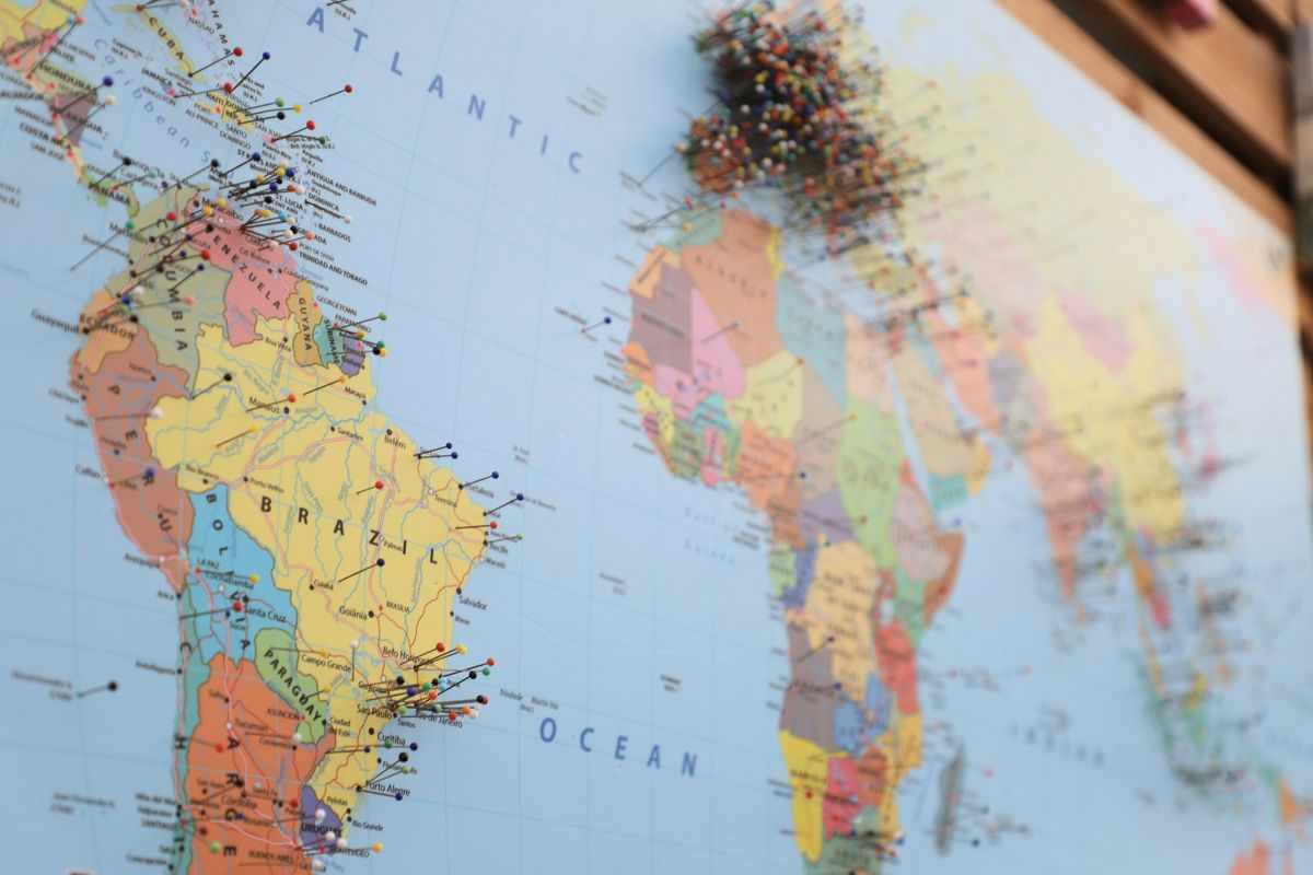 A world map marked with pins