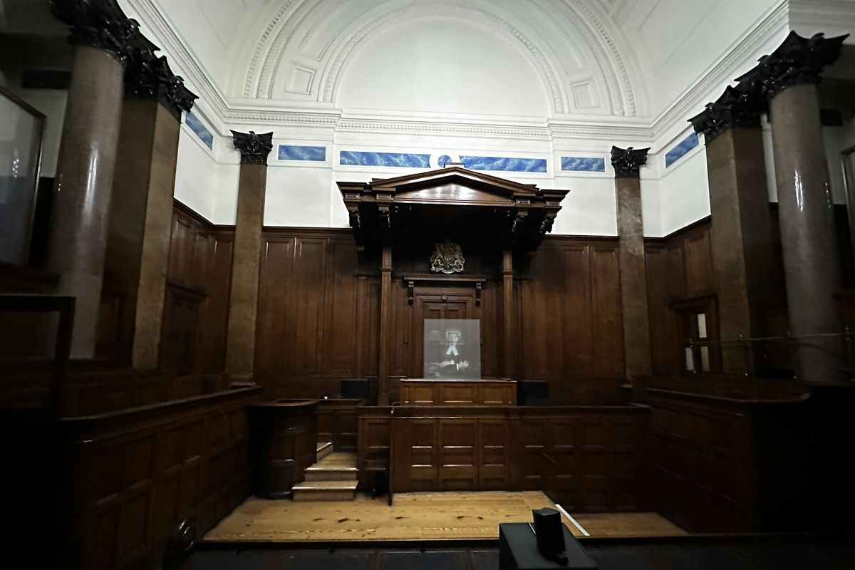 A dark, wood-panelled courtroom