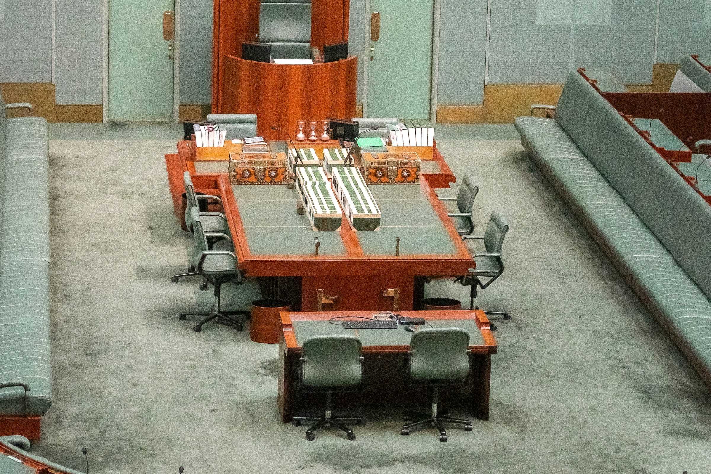 An empty assembly chamber with desks
