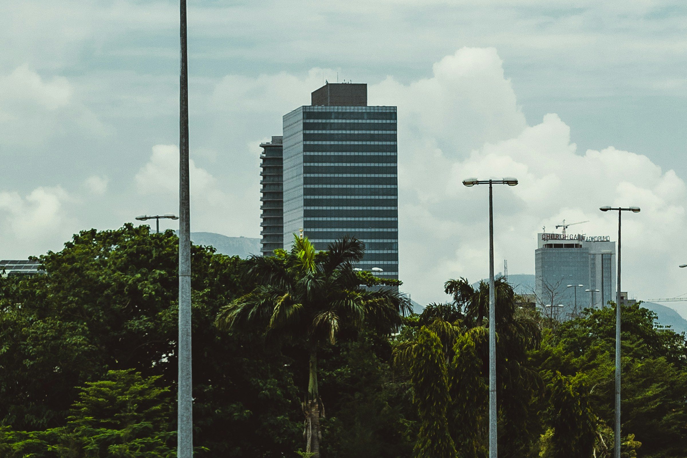 Office towers in Abuja under a cloudy sky