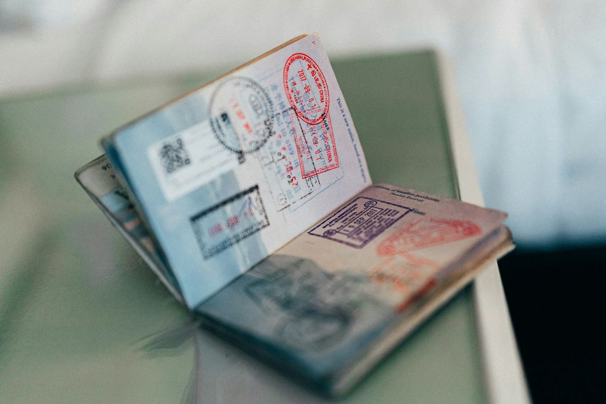 An open passport stamped with visas