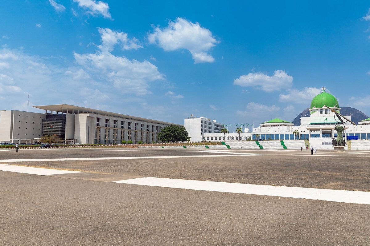 The National Assembly complex in Abuja under a blue sky