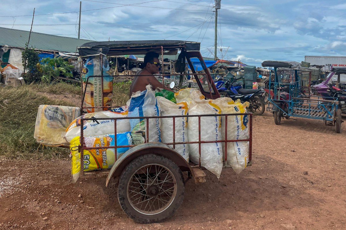 A three-wheeled vehicle loaded with sacks