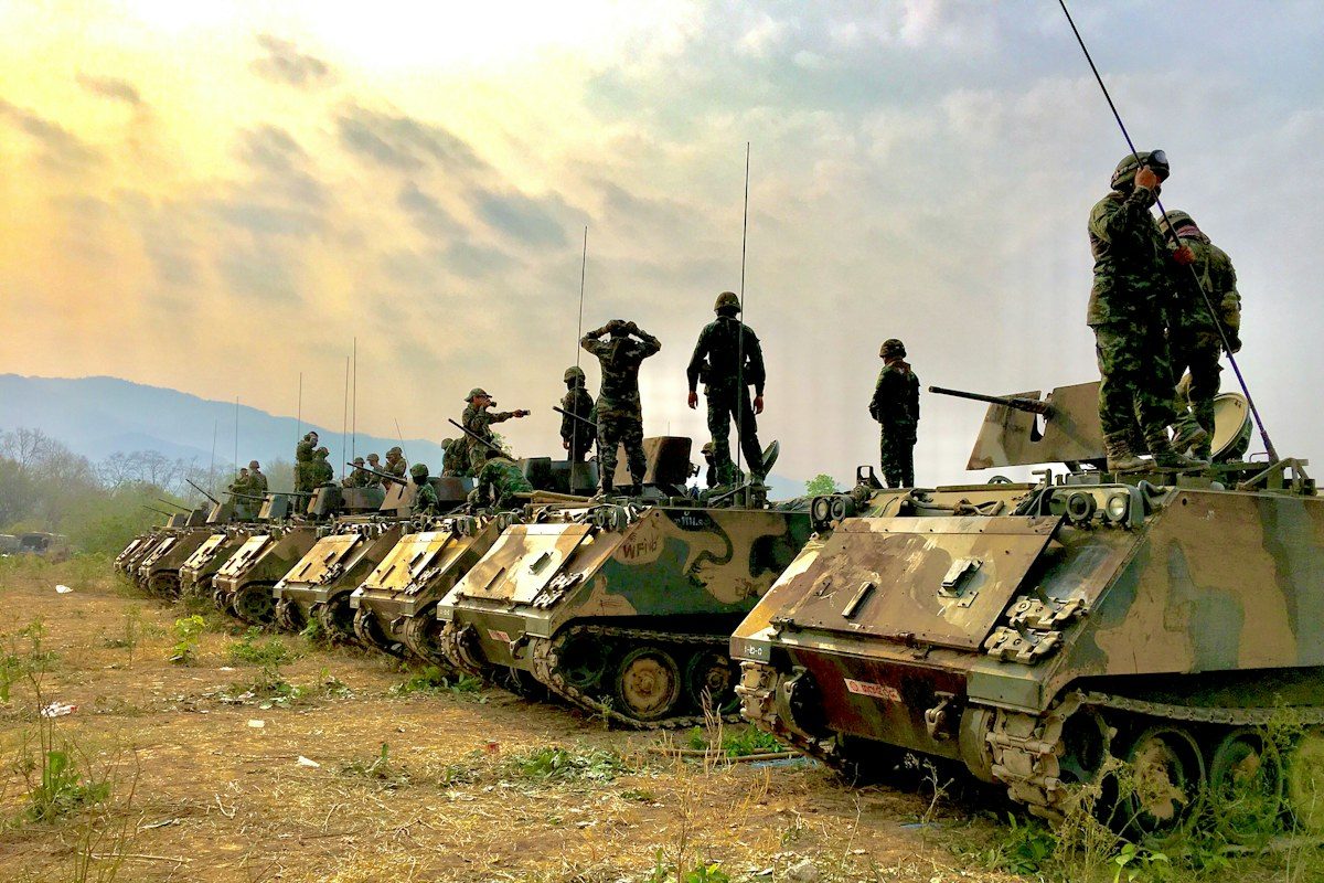 Soldiers on top of battle tanks