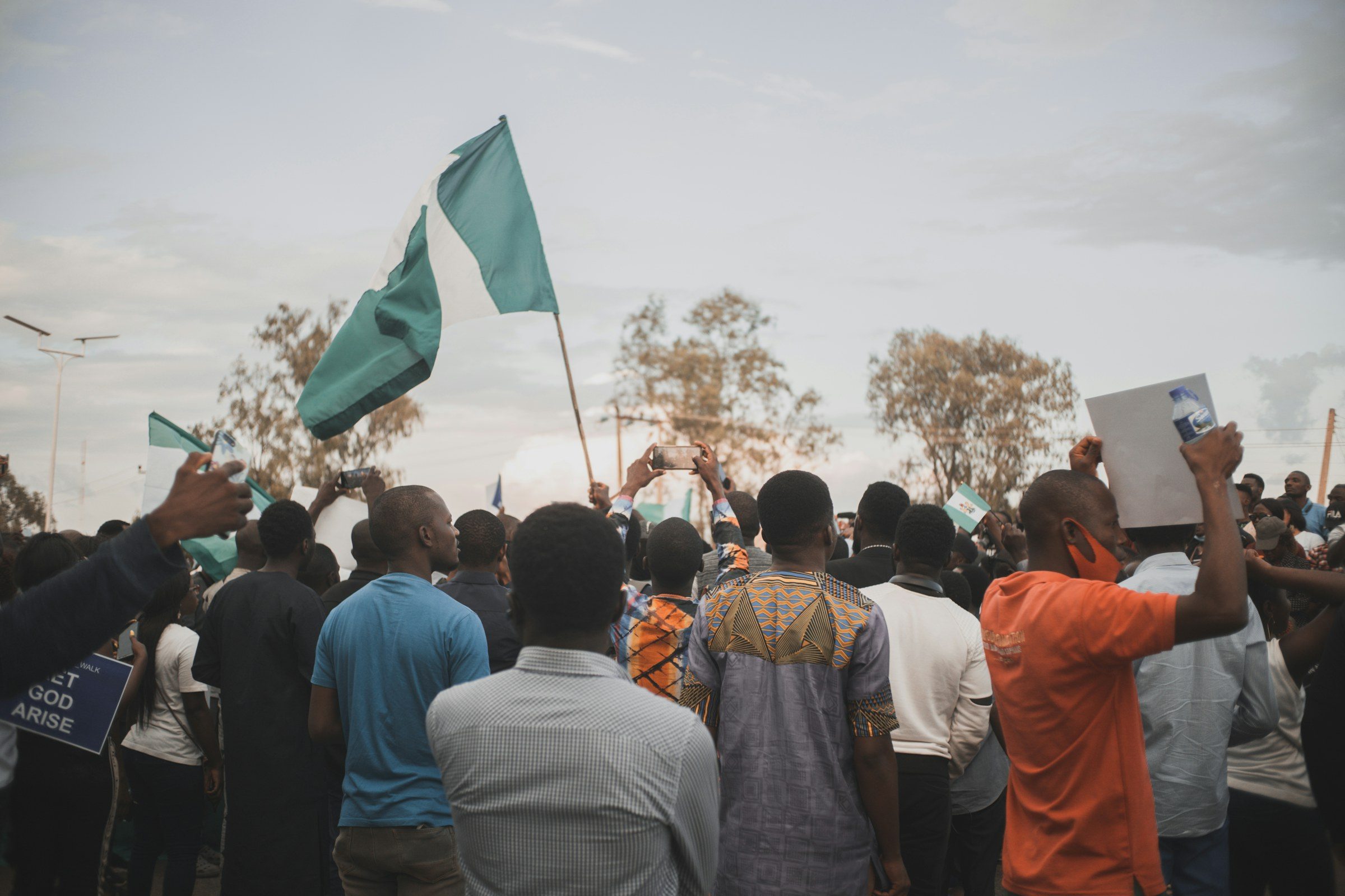 A crowd of demonstrators holding Nigerian flags