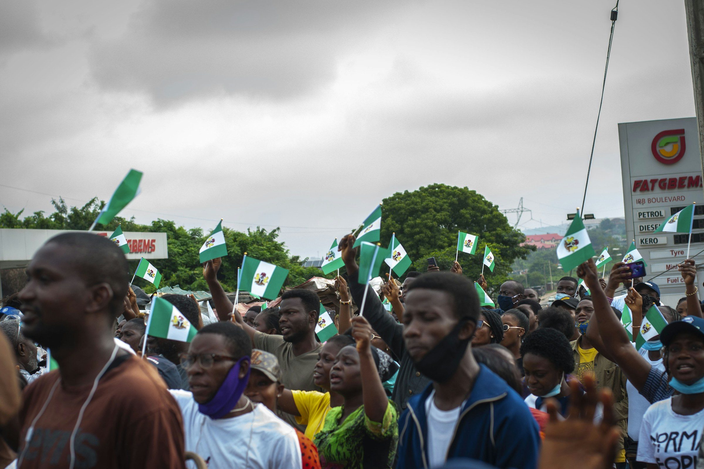 Supporters waving small Nigerian flags at a rally