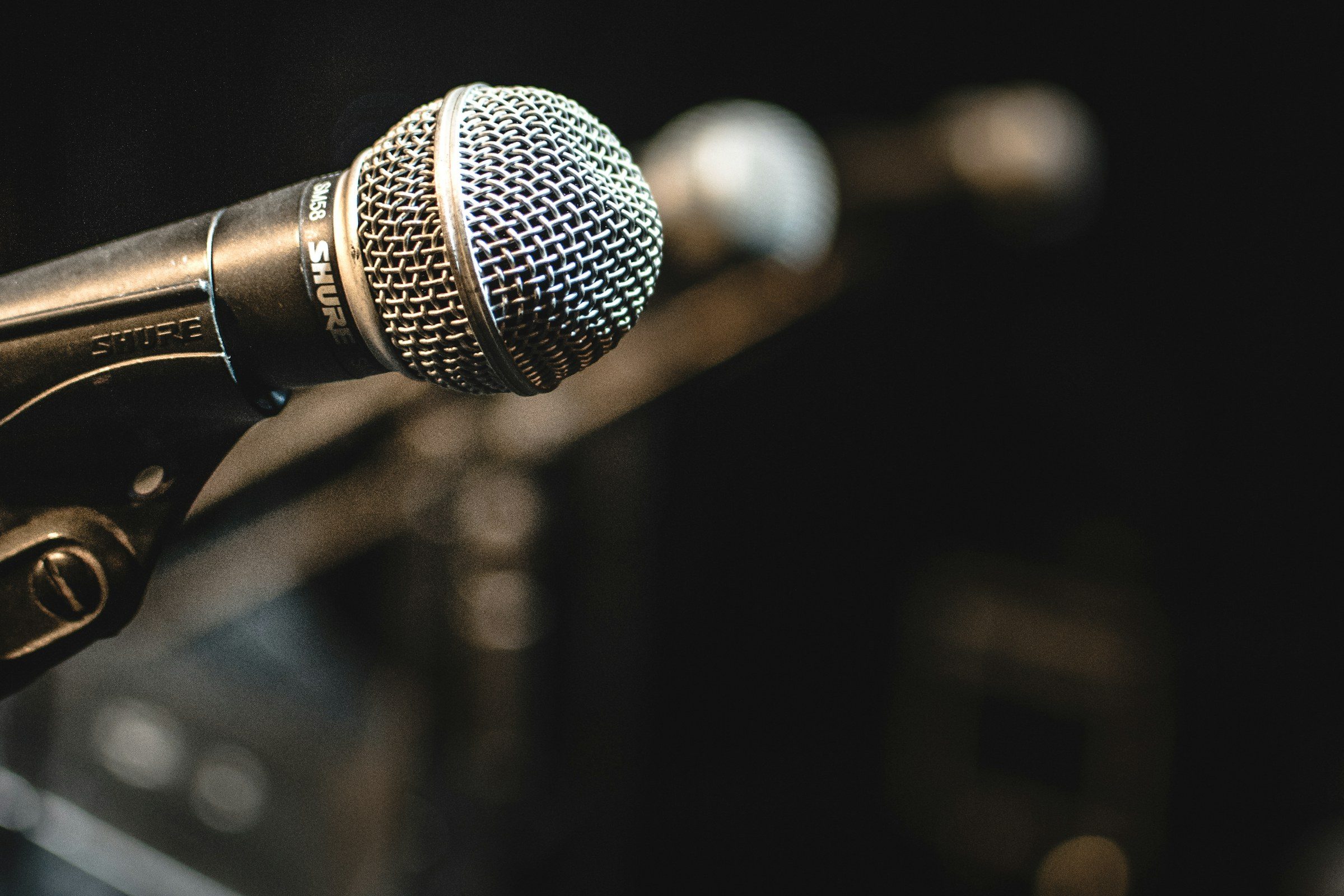 A single microphone against a dark background