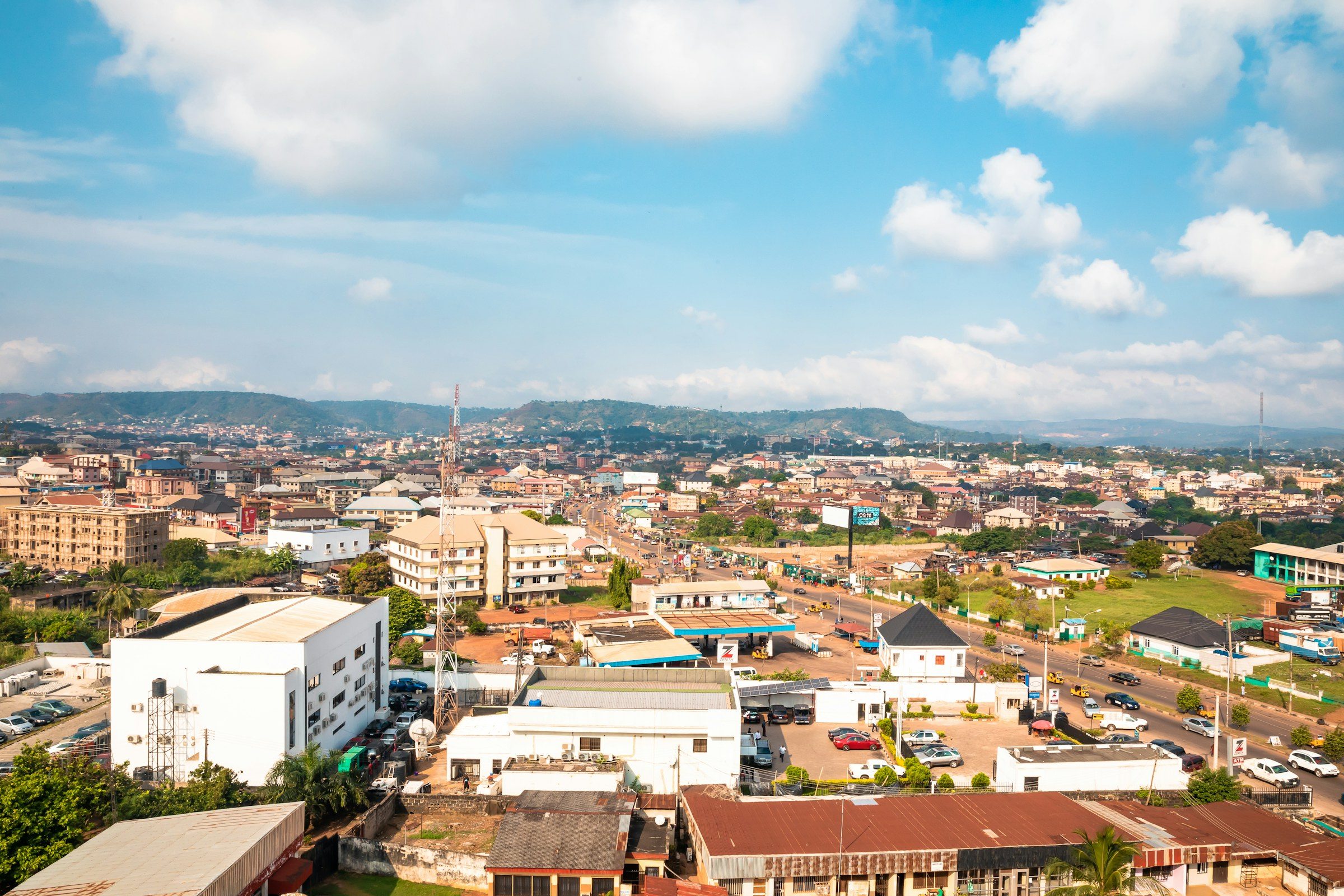 An aerial view of a Nigerian town under a blue sky