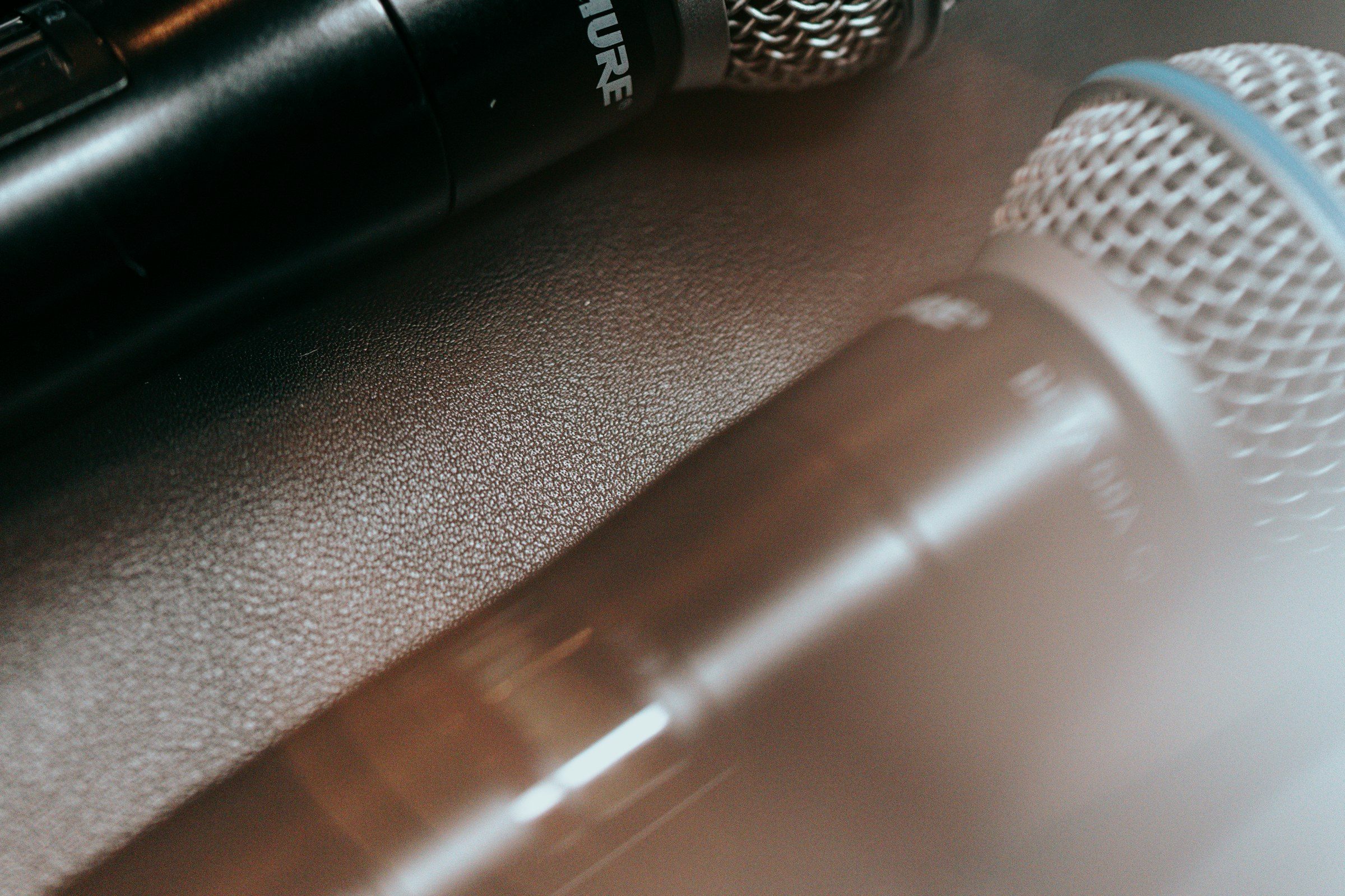 Two microphones on a table, in close-up