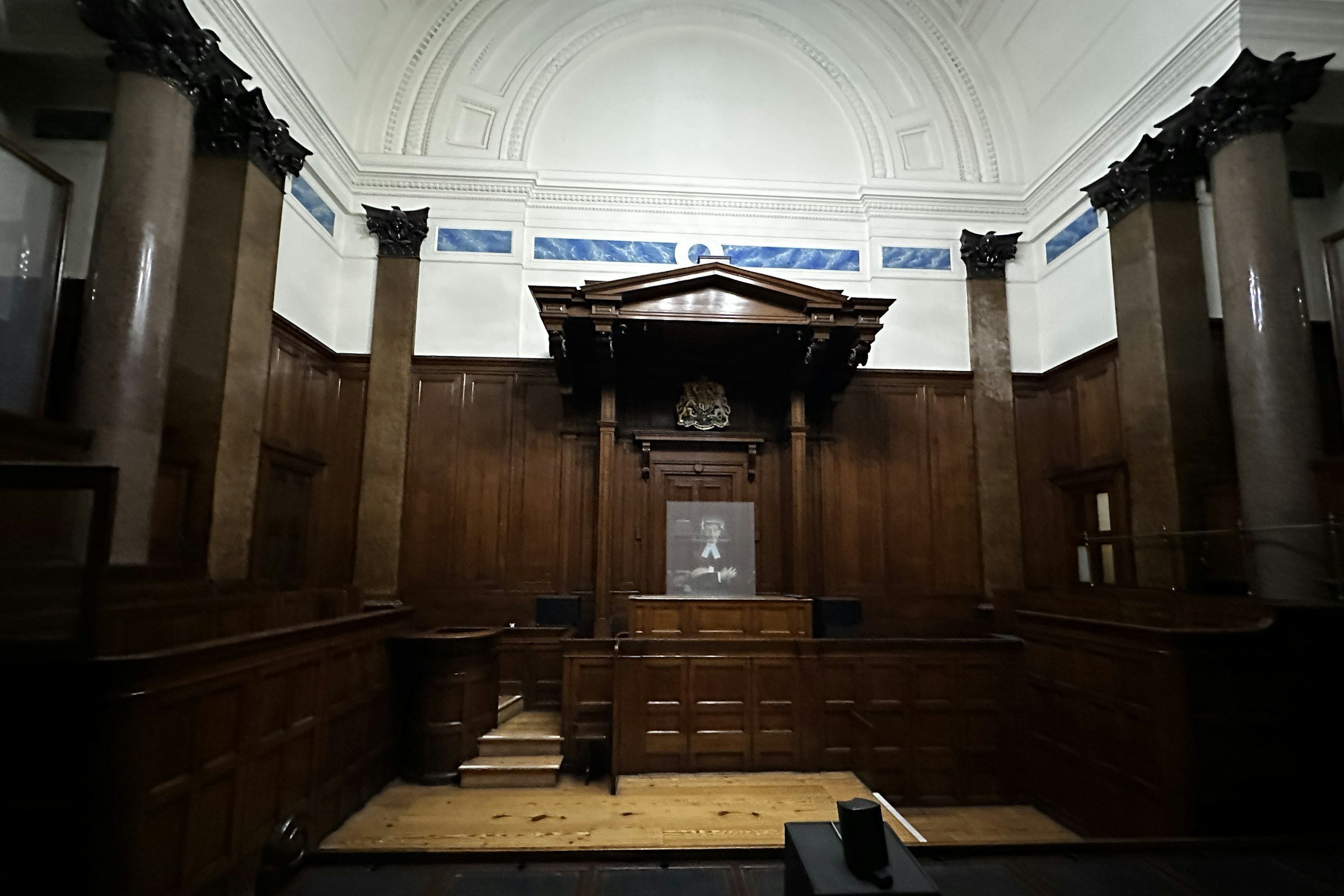 A dark, wood-panelled courtroom