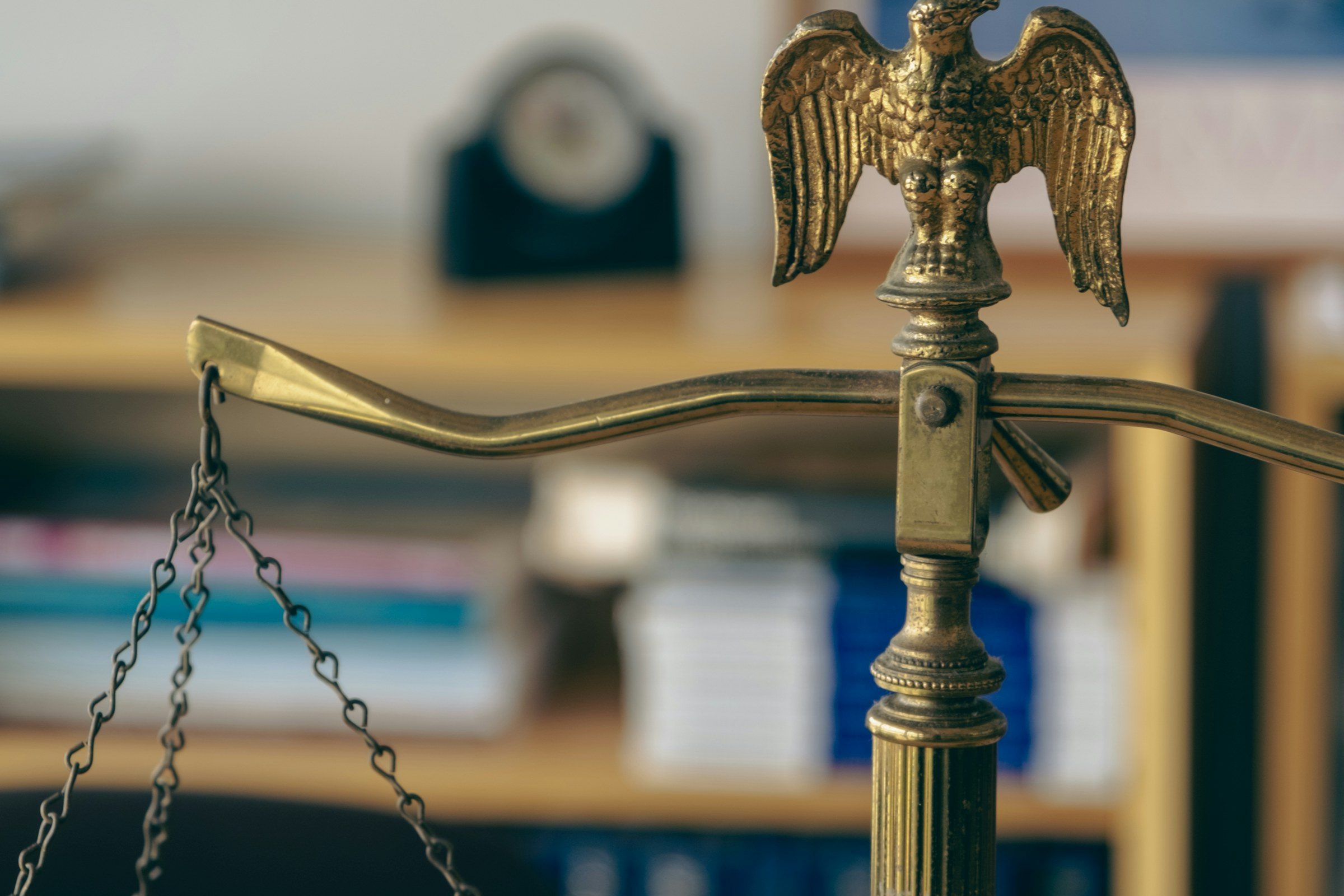 A brass balance scale in a law library